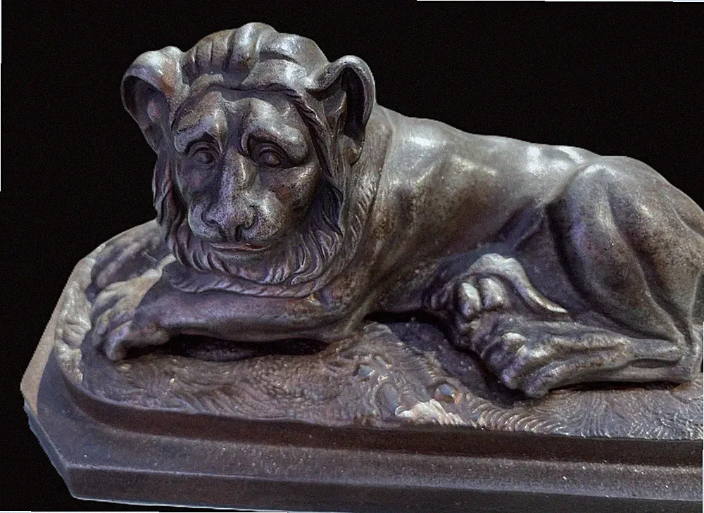 Antique Munkács cast iron reclining lion paperweight, circa 1830–1840.